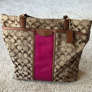 This is a large Coach bag. Colors are earth tones and a magenta center panel.